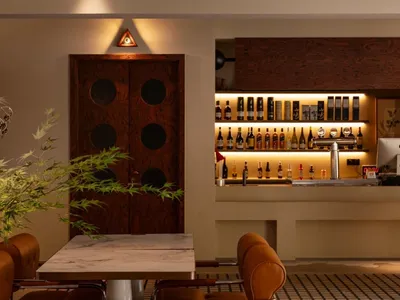 A modern cafe bar featuring wooden and marble materials
