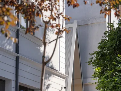 The exterior of a modern cafe featuring glass walls and wooden accents.