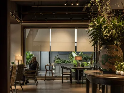 Industrial-style restaurant interior with glass windows.
