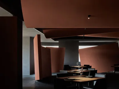 A sleek, modern restaurant interior with metallic elements and contemporary design.