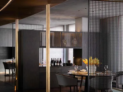 A contemporary restaurant interior with metal, glass, and wooden elements.