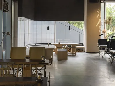 Industrial-themed restaurant interior with concrete and wooden elements.