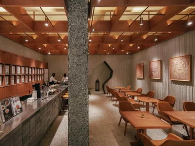 Modern restaurant interior with concrete and wood elements