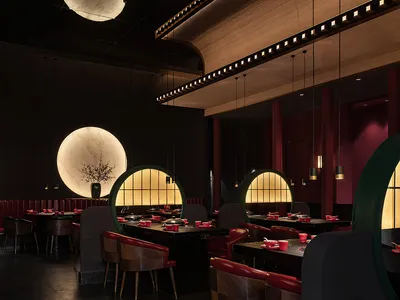 Industrial-style restaurant interior with metal, glass, and wood materials.