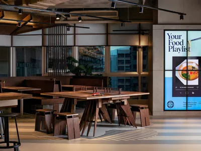 Modern restaurant interior featuring wooden furniture and contemporary design elements.