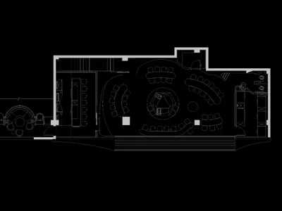 An overhead view of a modern restaurant floor plan featuring a central dining area surrounded by circular booths, and additio