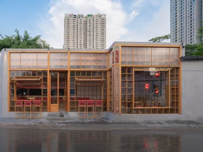 A modern restaurant exterior with glass paneling and wood frame
