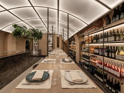 Industrial-style restaurant interior with concrete flooring and glass accents.