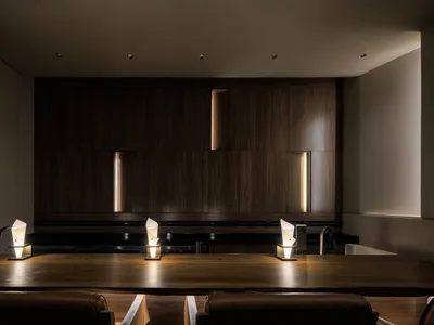 A modern restaurant bar interior with wooden furniture and ambient lighting