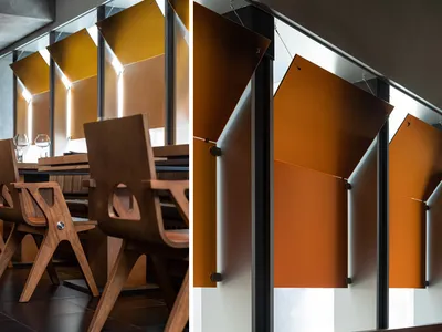 Modern restaurant interior featuring wooden furniture and metallic accents.