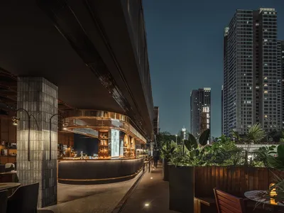Industrial-style restaurant bar with concrete, glass, and metal elements