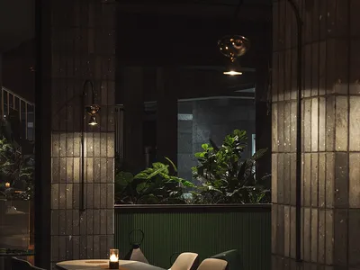 A modern minimalist restaurant interior featuring tiles and green plants