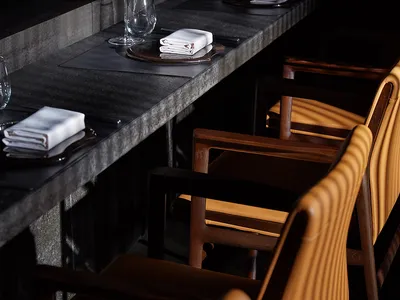 Dining room with concrete and leather elements in a modern restaurant setting.