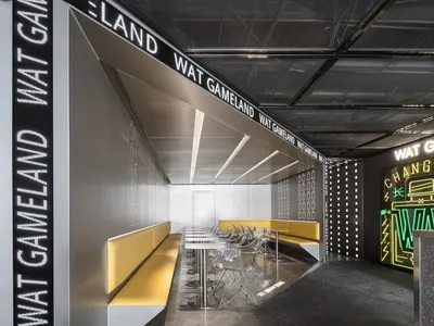 Modern restaurant interior with metallic and yellow elements