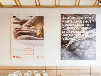 Modern restaurant interior featuring metal chairs and a tiled backsplash with concrete accents.