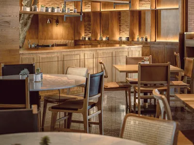 Modern restaurant bar featuring wooden shelves and decor.