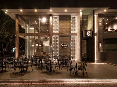 Modern restaurant exterior with concrete and glass materials.