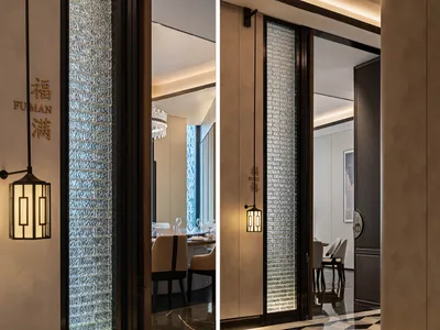 Modern interior design of a restaurant featuring glass panels and elegant lighting fixtures.