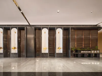 Modern hotel lobby featuring sleek, minimalist design with metal and wood accents.