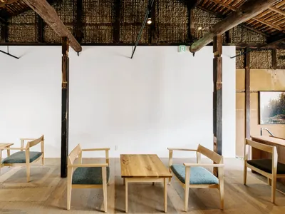 Modern restaurant interior with wooden furniture and minimalist design.