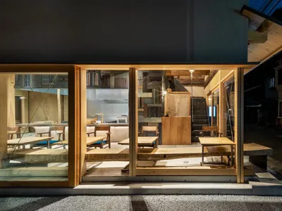 Modern, industrial-style restaurant interior featuring wooden tables and chairs.
