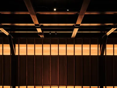 Industrial-themed restaurant interior with wooden banquettes and lighting