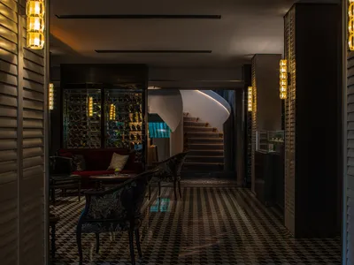 Modern hotel lobby featuring glass, wood, and metal materials