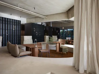 Modern restaurant interior with concrete and wooden elements.