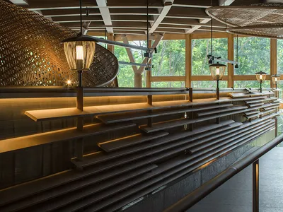 A modern restaurant interior featuring wooden elements.