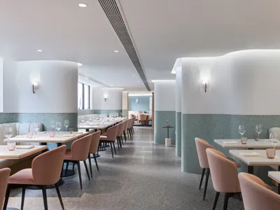 A minimalist restaurant interior featuring terrazzo accents and modern design elements.