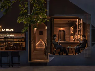 A cozy, modern restaurant bar with wooden finishes and a warm, inviting atmosphere.
