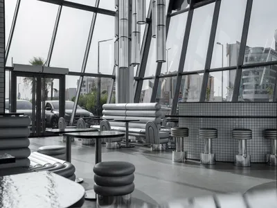 Modern restaurant interior with large glass walls and sleek, contemporary furniture.