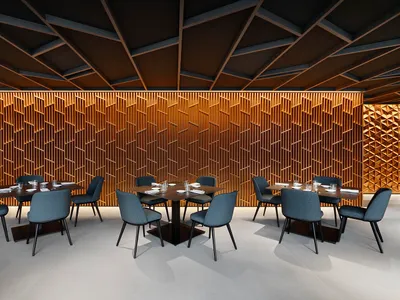 A modern restaurant interior with wooden walls, fabric chairs, and tables.