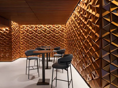 Modern restaurant interior with wooden decor and high-top seating