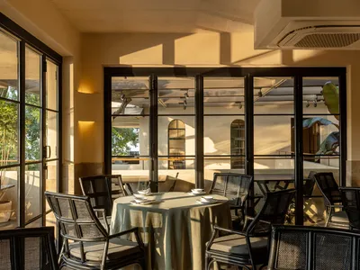An indoor cafe with metallic furniture and a minimalist design.