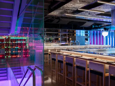 Modern restaurant bar interior with glass walls and seating