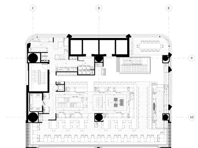 A technical 2D drawing of a modern restaurant designed with concrete materials, showing the layout of the kitchen, dining are