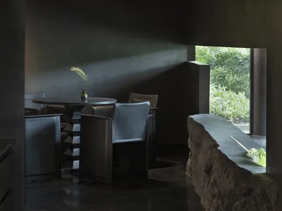Modern restaurant interior featuring concrete and glass materials