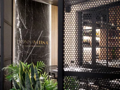 The interior of a modern restaurant featuring a marble accent wall.