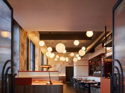 Industrial-style restaurant interior with metal, wood, and concrete elements