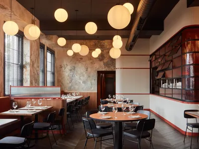 Modern restaurant interior featuring wood, concrete, and glass materials