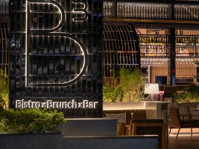 A modern restaurant exterior featuring metallic elements and a contemporary design.