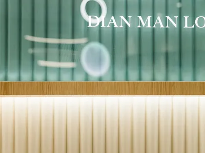 Modern restaurant signage displayed in glass material.