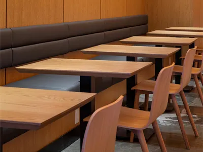 Modern restaurant interior featuring wooden furniture and sleek design.