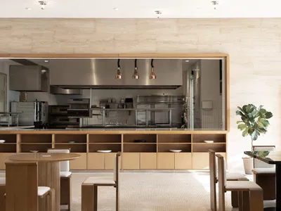 Industrial-style restaurant interior with copper pendant lights and wood furnishings.