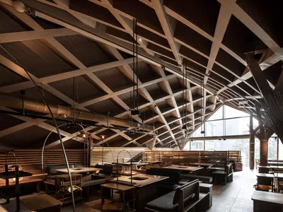 Industrially designed restaurant interior with wooden beams on the ceiling
