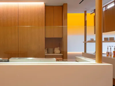 Modern restaurant interior featuring a wooden counter and minimalist design elements.