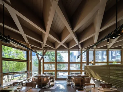 Modern restaurant interior featuring concrete and glass elements.