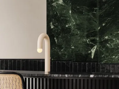 A modern bar counter with dark marble surfaces and minimalist design features.