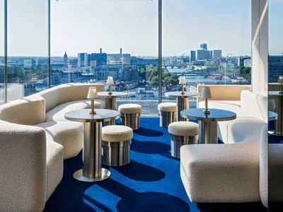 Modern hotel lobby featuring a combination of marble and fabric elements.